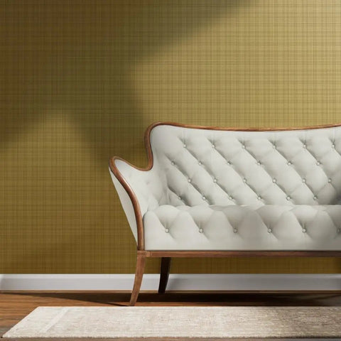 Next Level Neutral Plaid Tan And Gold Metallic Wallpaper With Luxe Fiber Texture Eco Friendly Pvc Free Wallcovering Made In Usa showcased behind a white tufted sofa.