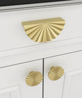 Front view of Six Pack Gold Cabinet Handles And Drawer Pulls Set with sunflower petal design on a white cabinet drawer