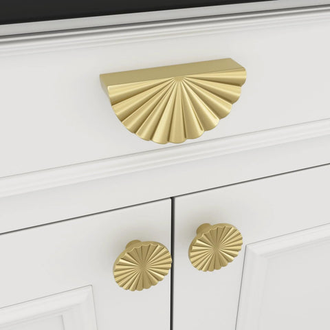 Front view of Six Pack Gold Cabinet Handles And Drawer Pulls Set with sunflower petal design on a white cabinet drawer
