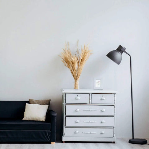 Energy Efficient LED Light Bulbs A19 9W 60W Equivalent E26 Base Soft White 2700K Dimmable in home office setting with a sofa and lamp.
