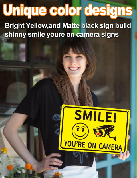 Woman holding 4 Pack Smile Youre On Camera Signs 8x12 Rust Free Aluminum Outdoor Video Surveillance Signs With UV Print.