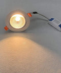 JUDYSSY Adjustable Led Floodlight 3-15W High Efficiency Cob Ceiling Light with warm illumination on a surface.