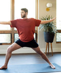 Person practicing yoga on XL Rubber Yoga Mat 78 Inch By 28 Inch Storm Color With Dual Sided Non Slip Grip Roomy One Quarter Inch Thick Cushion Natural Sustainable Rubber Durable For Home Practice And Studio Flows And Deep Stretches in home setting.