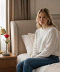 Rock Solid Bloom Bud Vase With Heavy Granite Base And Glass Flower Holder on bedside table next to woman sitting on bed