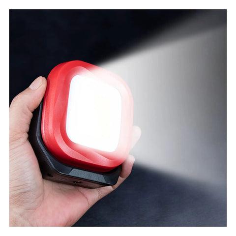 Hand holding the Beast COB LED Work Light With 42 LEDs, 1000 Lumens, Rechargeable Portable Magnetic Inspection Flashlight, emitting bright light