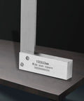 Angled front view of steel machinist square, L-type, 100x63mm wide-seat right-angle measuring tool on wood surface.
