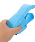 Hand holding blue Ergonomic Packing Tape Dispenser And Cutter For Quick Box Sealing With Smooth Glide And Broad Tape Compatibility, Fatigue Free Use, And Precise Cut Pro Grade Tape Gun For Warehouse, Shipping, Moving And Office Tasks.
