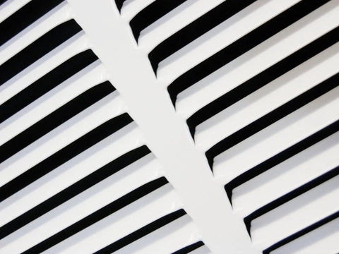 Close-up of 12 X 18 Inch Flat Stamped Steel Return Air Grille For Duct Opening with angled fins and white finish.
