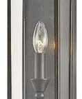 Chauncey Small Wall Sconce In Vintage Bronze With Clear Glass showcasing hand worked iron finish, perfect for cozy retro hallway or living room.