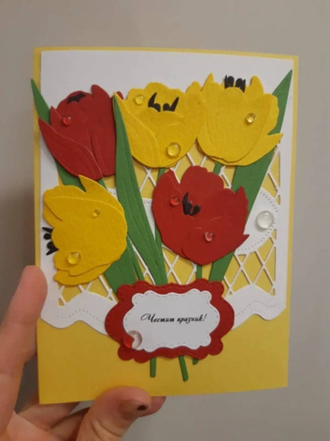 Hand holding card made with Dope Flower Die Cut Set For Card Making And Scrapbooking, featuring red and yellow flowers with stencil detail.