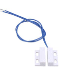 White surface mount magnetic proximity reed switch with blue wires, normally open, 110-220V AC door sensor hidden in door frame.