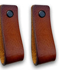 Leather Furniture Handles Set Two Pieces Cognac Leather Drawer Pulls For Cabinets Dressers Kitchen And Bathroom Wood Furniture Six And A Half Inch Length Featuring Durable Craftsmanship And Industrial Style Accents For Modern Homes. Side view of brown leather loops with black button detail.