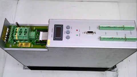 Compax M 1560M Compact Servo Controller For Precision Motion And Automation, Used Good Condition, 18.67 Lb Weight, 22 X 6 X 16 Inch Dimensions, High Efficiency Servo Drive For CNC Machines And Robotic Systems. silver metal servo controller with green terminal blocks