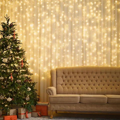 300 LED Fairy Curtain Lights USB Plug In 9.8 By 9.8 Feet Warm White With 8 Modes Indoor Outdoor Waterproof IP44 lights behind sofa and tree.
