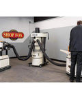 Portable 2 HP Cyclone Dust Collector With 7 Inch Inlet, 20 Gallon Drum, 1023 CFM Airflow, 3450 RPM in a workshop setting