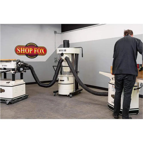 Portable 2 HP Cyclone Dust Collector With 7 Inch Inlet, 20 Gallon Drum, 1023 CFM Airflow, 3450 RPM in a workshop setting