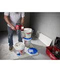 Worker using 18V Cordless Mud Mixer Bare Tool for Drywall Mud Plaster and Concrete Projects, mixing in a bucket on jobsite
