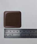 Brown square slider with ruler, part of Eight Pack Self Stick Furniture Sliders Brown Square Self Adhesive Carpet Sliders Furniture Moving Pads Glides For Sofas Chairs And Tables Easy To Install No Hassle Setup