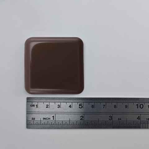 Brown square slider with ruler, part of Eight Pack Self Stick Furniture Sliders Brown Square Self Adhesive Carpet Sliders Furniture Moving Pads Glides For Sofas Chairs And Tables Easy To Install No Hassle Setup