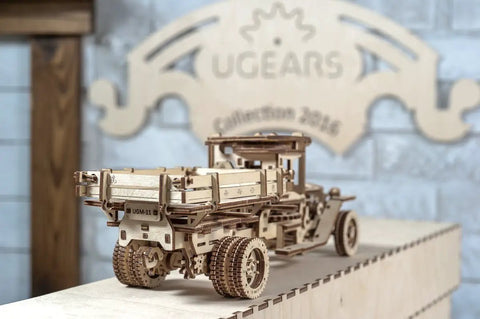 3D Self Propelled Wooden Model Truck UGM 11 Kit For Gearhead Builders And Collectors With Gear Driven Mechanism Realistic Wood Finish About 10 To 12 Hours Assembly Durable Brown Wood Craft Project That Feels Like Vintage Tech, rear view on display