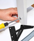 Installation of Spring Loaded Cabinet Hinge Pair For Lift Doors And 85-Degree Vertical Folding, showing a screwdriver in action.