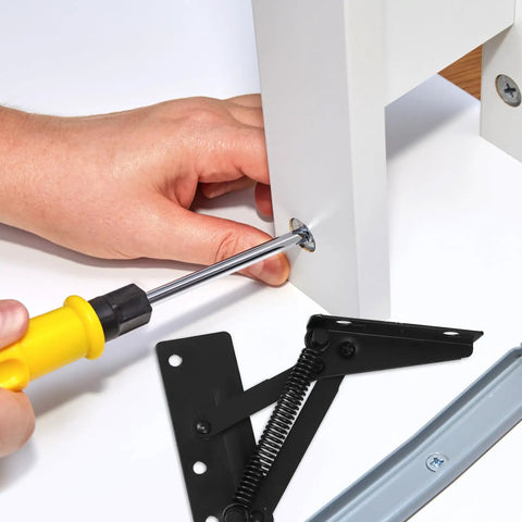Installation of Spring Loaded Cabinet Hinge Pair For Lift Doors And 85-Degree Vertical Folding, showing a screwdriver in action.