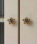 Bougie Antique Brass Flower Cabinet Knobs Vintage Aesthetic Boho Decor Hardware Set of 4 on white cabinet doors.