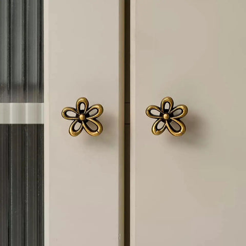 Bougie Antique Brass Flower Cabinet Knobs Vintage Aesthetic Boho Decor Hardware Set of 4 on white cabinet doors.