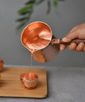 Pouring from Copper Teapot With Wooden Handle Dope Hammered Turkish Coffee Pot Multipurpose Kettle For Tea Coffee Maple Syrup And Sauce Heating Hand Crafted In Turkey For Your Home Kitchen
