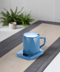One Tap Control Keeps Your Morning Brew Piping Hot At 55 Degrees This Ceramic Coffee Cup Warmer on a desk with plants.