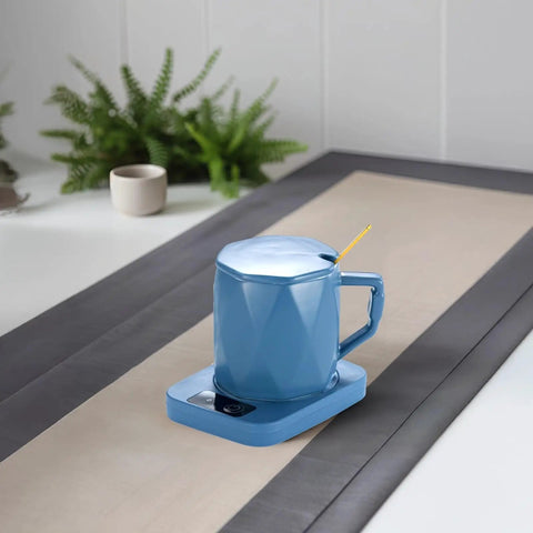 One Tap Control Keeps Your Morning Brew Piping Hot At 55 Degrees This Ceramic Coffee Cup Warmer on a desk with plants.