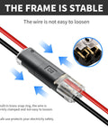 Two-pin quick-splice low-voltage wire connector; clear housing shows brass contacts with red and black wires