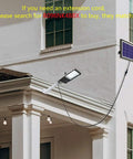 Solar Street Light Outdoor IP65 Security Flood Light with Remote Control installed on building, solar panel visible