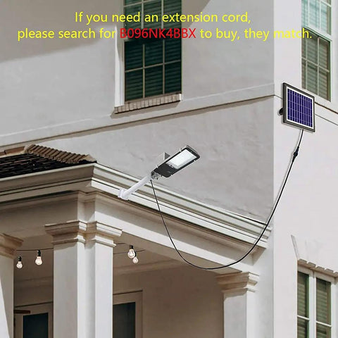Solar Street Light Outdoor IP65 Security Flood Light with Remote Control installed on building, solar panel visible