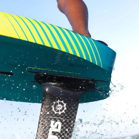 Close-up of Wing Craft V2 Wingsurf Foil Board 50 L with flat bottom and hard rails slicing through water, focus on foil mount.