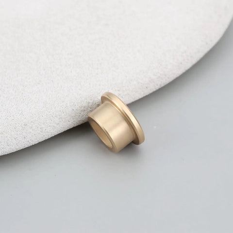 8 Pack Flanged Copper Sleeve Bushings 8 Mm Bore 12 Mm OD 8 Mm Long on a smooth surface, showing copper material and flanged design.