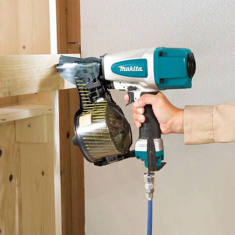 Premium Pneumatic 15 Degree Siding Coil Nailer With Tool-Less Depth Adjustment And Nine Detents in use on wood siding