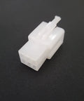 White plastic connector for Hub Motor Nut And Washer Kit For Electric Bikes, Wheel Lock Nuts And Axle Bolts, on dark background.