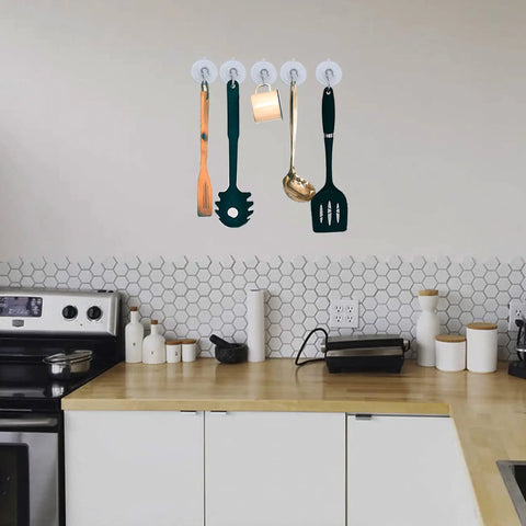 Kitchen utensils hanging on a wall using three size suction cup hooks set for shower glass and walls with mega strong hold up to seven pounds
