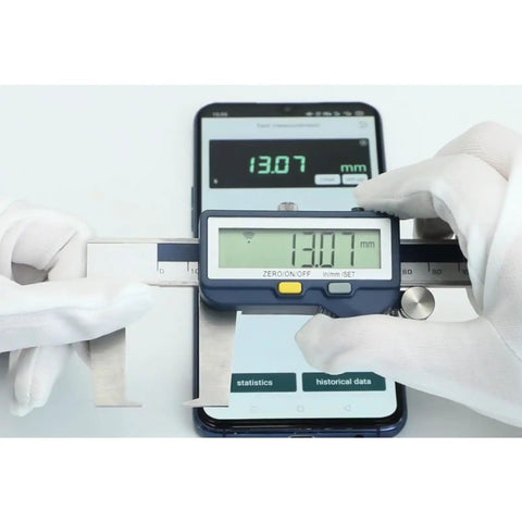 Digital Outside Neck Caliper With Built In Wireless Data Transmission; Measures Grooves And Recesses In mm Or Inches; Stainless Steel, IP54 Rated, 6 Inch Capacity; Quick Device Sync For Precise, Pro Grade Machining Measurements, shown measuring with a smartphone.