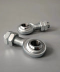 Built Tight For Your Daily Driver Rig Drop Right In Heim Joint Rod End Kit Three Quarter Sixteen CmR12 Male Spherical Bearing Locking Nut Link Rod Suspension Arm 45 Carbon Steel 52100 Zero Play Control Eighteen Thousand Pounds 2 Piece Set, close-up of two male heim rod ends with locking nuts.