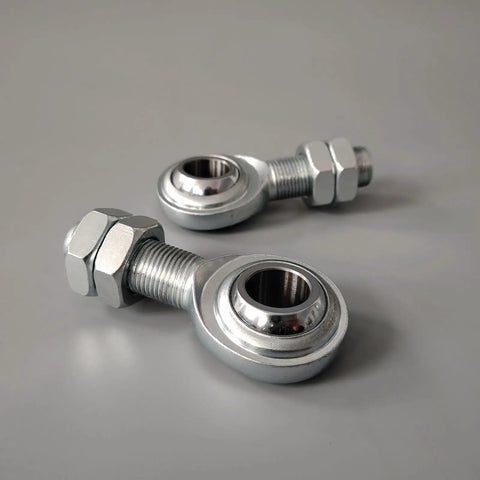 Built Tight For Your Daily Driver Rig Drop Right In Heim Joint Rod End Kit Three Quarter Sixteen CmR12 Male Spherical Bearing Locking Nut Link Rod Suspension Arm 45 Carbon Steel 52100 Zero Play Control Eighteen Thousand Pounds 2 Piece Set, close-up of two male heim rod ends with locking nuts.