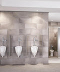 Pintbrook Top Spud Urinal High Efficiency Flush 0.125 to 0.5 GPF White in a modern restroom with tiled walls.