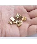 Top Shelf 50 Pack Mini Brass Hinges With A Seamless 180 Degree Swivel For Micro Crafts and Tiny Cabinet Fixes on a hand.