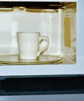 A mug inside a microwave with visible mica waveguide cover from the 4 Pc Waveguide Cover Replacement Kit With Scissors, 150Mm By 120Mm Mica Plates Sheets.