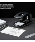 Tough As Nails Heavy Duty 2 Hole Punch For Office, School, And Home, 100 Sheets Capacity on desk with tools and dimensions