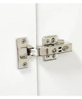 Close-up of stainless steel cabinet door hinge with hydraulic damper soft close quiet wardrobe concealed with screws half overlay.