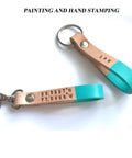 Two half inch natural vegetable tanned leather keychain blanks ready for custom stamping with snap hooks.