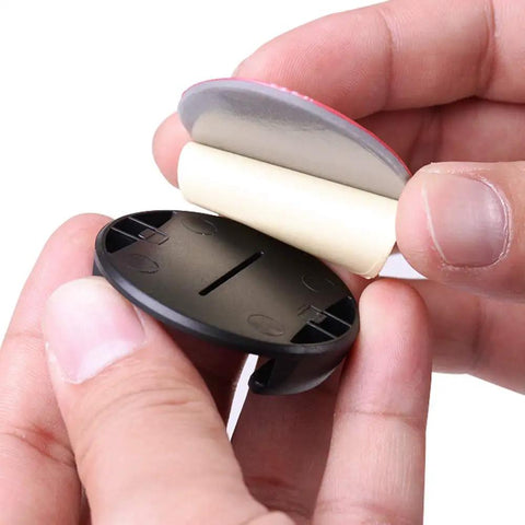 Quick Release Flat And Curved Surface Camera Mount With Strong Adhesive Base being held, showcasing peel-and-stick design for easy use.