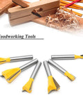 Shop Tested Six Piece Dovetail Router Bit Set Featuring One Quarter Inch Shank And Cutting Widths Spanning A Quarter To Seven Eighths Inches Crafted From Tough Tungsten Carbide For Knocking Out Tight Half Blind Woodworking Joints Dead On And Fast, displayed with wood shavings.